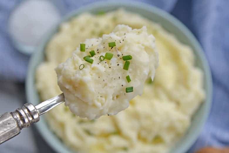 Spoon of creamy mashed potatoes 