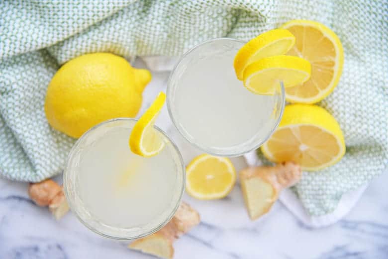 Overhead of ginger lemon water on marble 