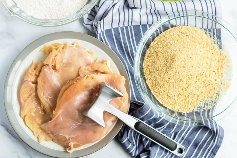 Raw chicken breasts with bread crumbs 