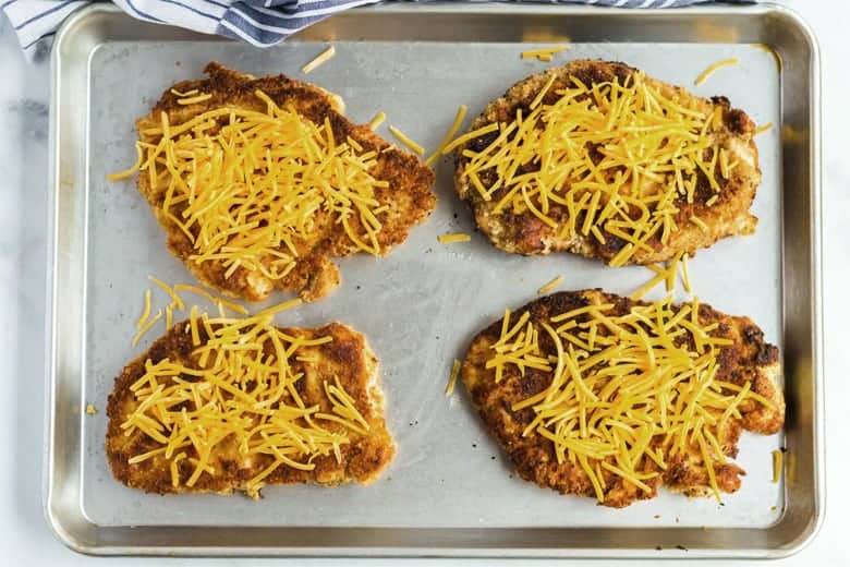 Fried chicken breasts with cheddar cheese