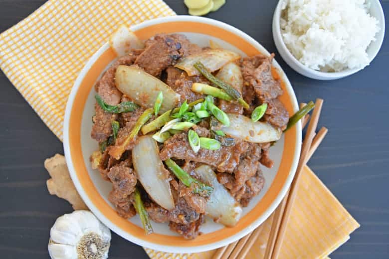 Mongolian Beef on a serving plate with chopsticks