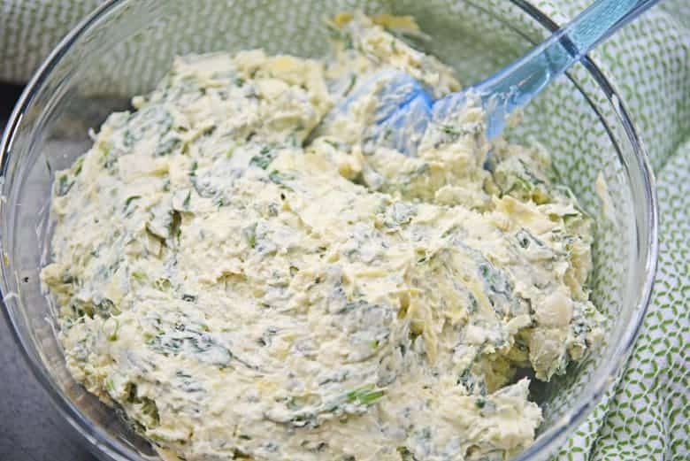 Spinach artichoke dip in a mixing bowl 