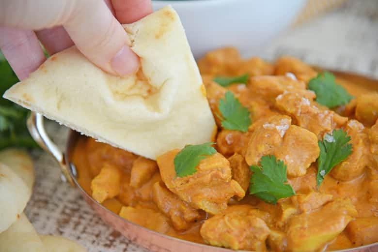 Naan and butter chicken with cilantro 