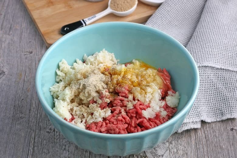 Cabbage roll stuffing in a blue mixing bowl 
