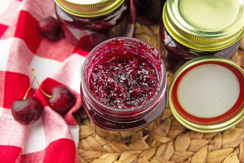 Overhead of cherry jam in a mason jar. 