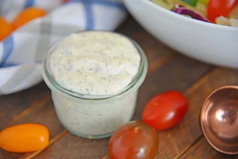 glass bowl of ranch dressing with tomatoes 