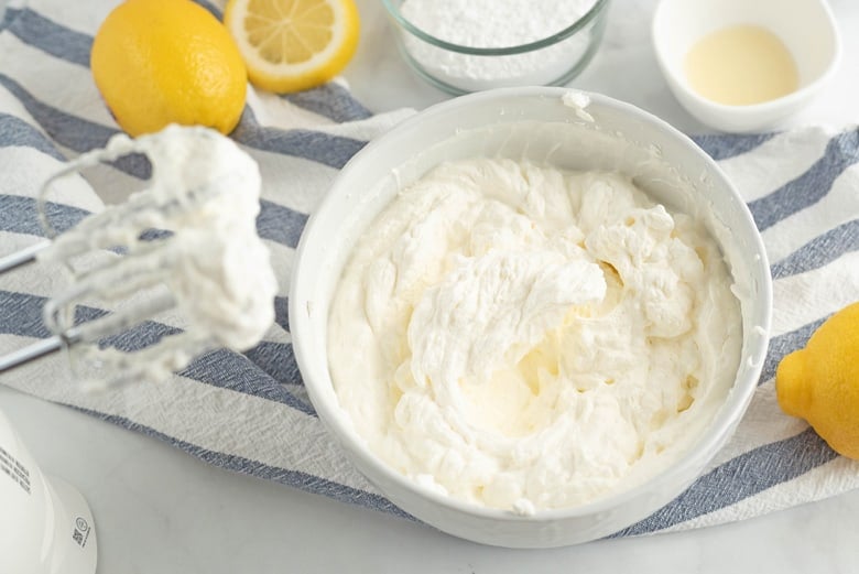 Whipped lemon frosting in a white bowl