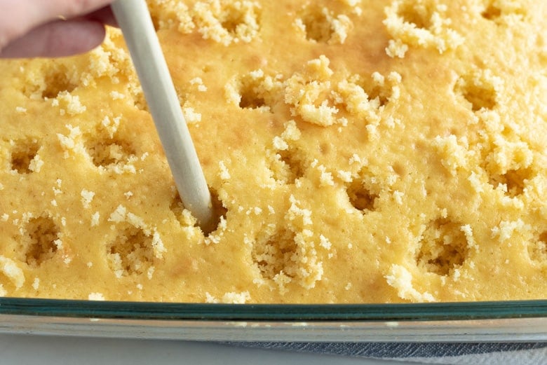 Poking holes into cooked cake 