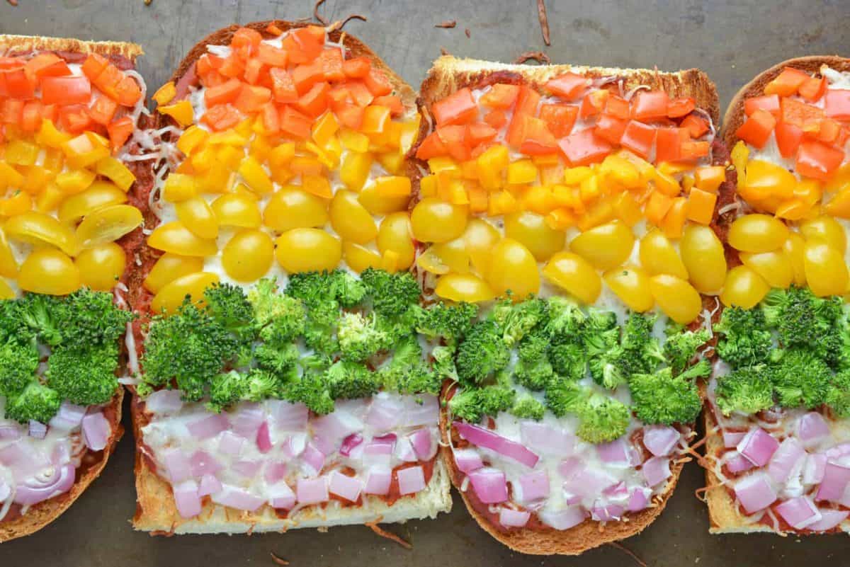 rainbow french bread pizza on a baking sheet 