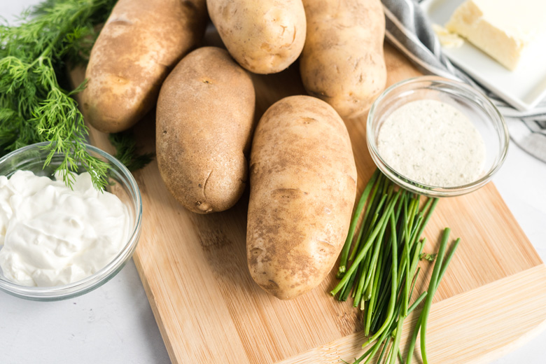 Russet potatoes on a cutting board 