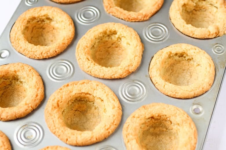 Empty cheesecake cups in a muffin tin 