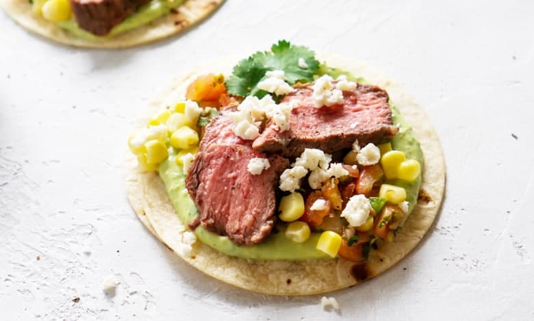 steak tacos with corn, cheese and pico de gallo 