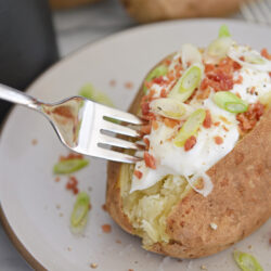 fork digging into a baked potato