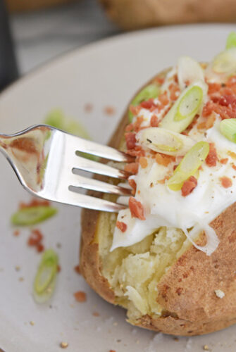 fork digging into a baked potato
