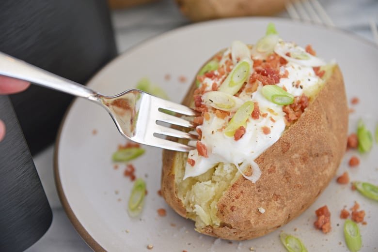 fork digging into a baked potato