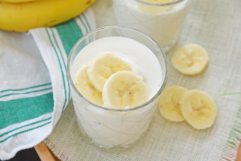 overhead of banana smoothie in a glass