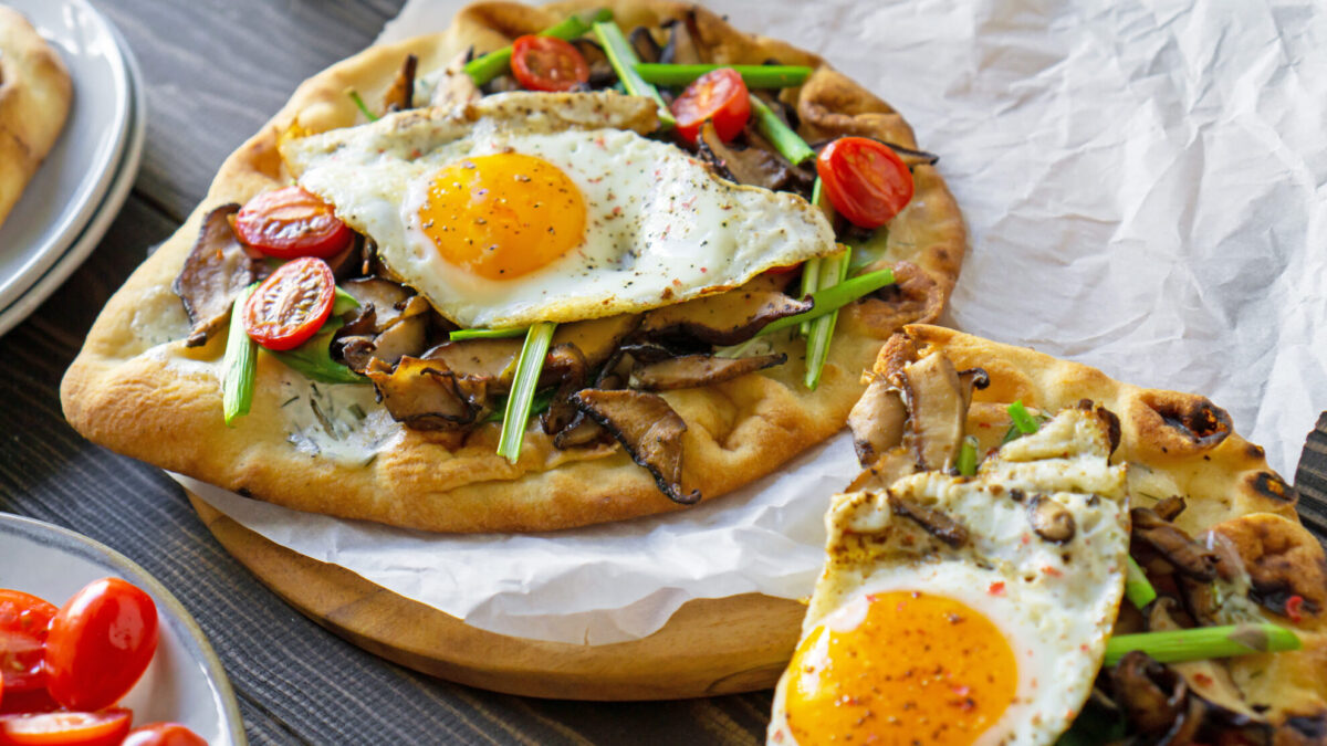 Vegetable breakfast pizza being served 