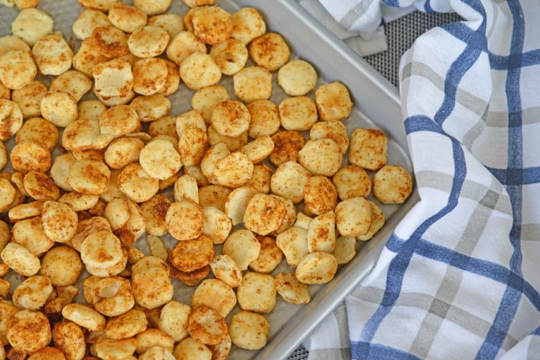 cajun oyster crackers on a rimmed baking sheet  