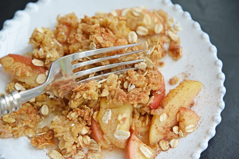 fork cutting into apple crisp 