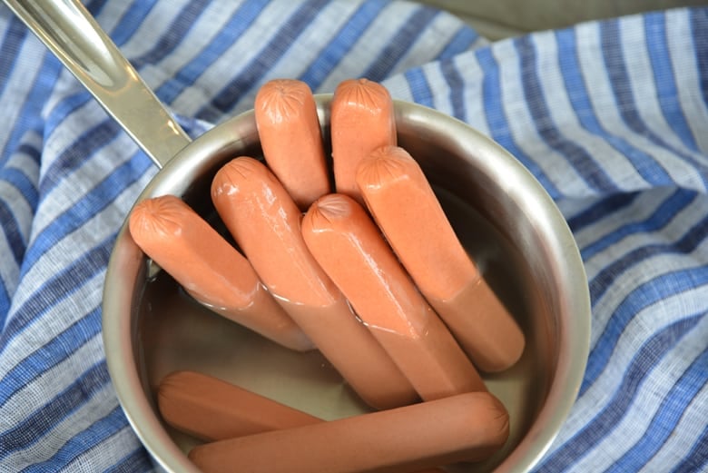 all beef hot dogs in a saucepan 