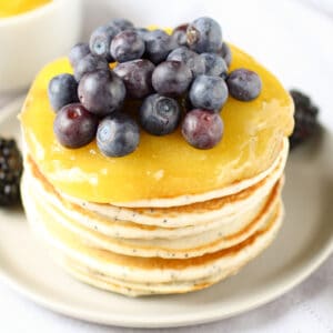 stack of pancakes with lemon curd and blueberries