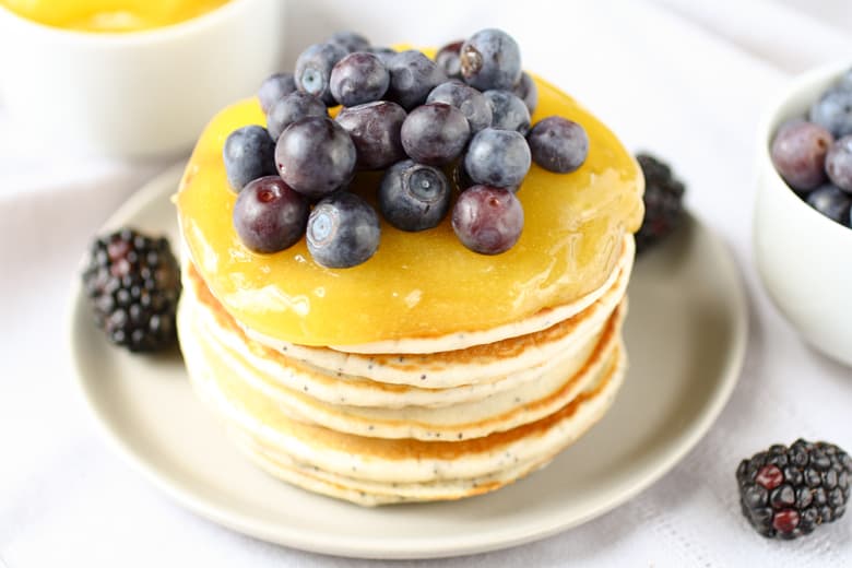 stack of pancakes with lemon curd and blueberries