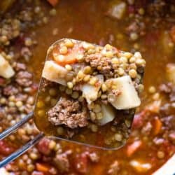 overhead shot of lentil stew in a ladle