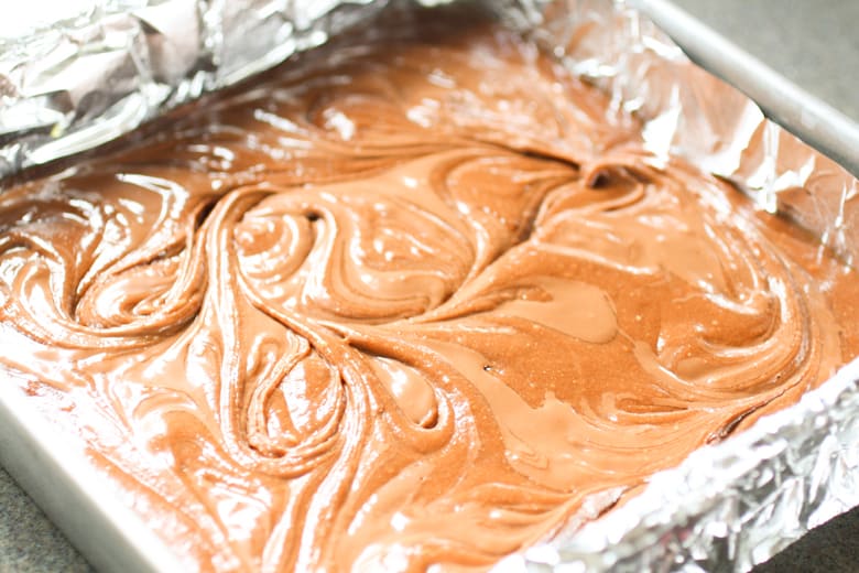 brownie batter in a baking dish 