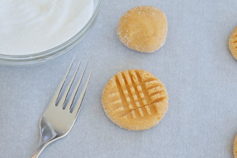 peanut butter cookie being crosshatched with a fork 