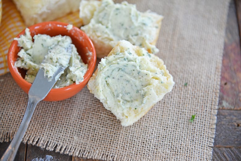 buttering a roll with homemade ranch butter 