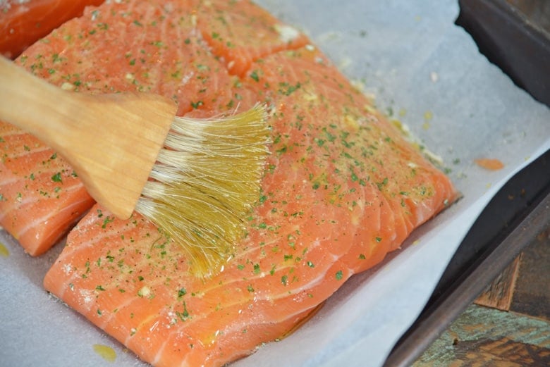 Basting salmon filet with ranch seasoning 