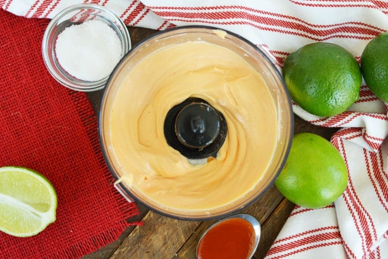 spicy aioli sauce in a food processor with limes 