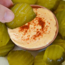 pickle dipping into spicy aioli