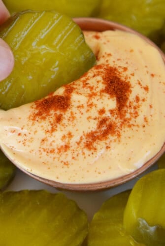 pickle dipping into spicy aioli