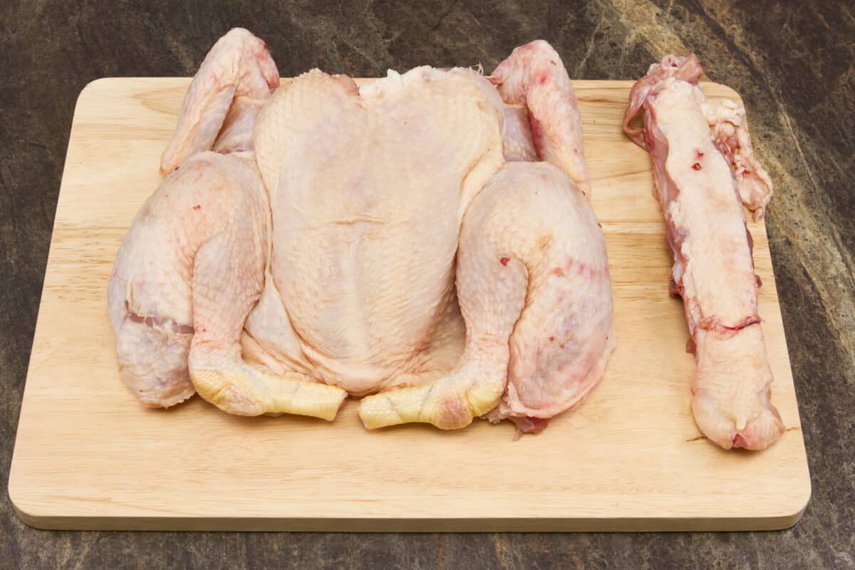 spatchcocked chicken on a cutting board 