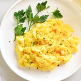 white plate with scrambled eggs