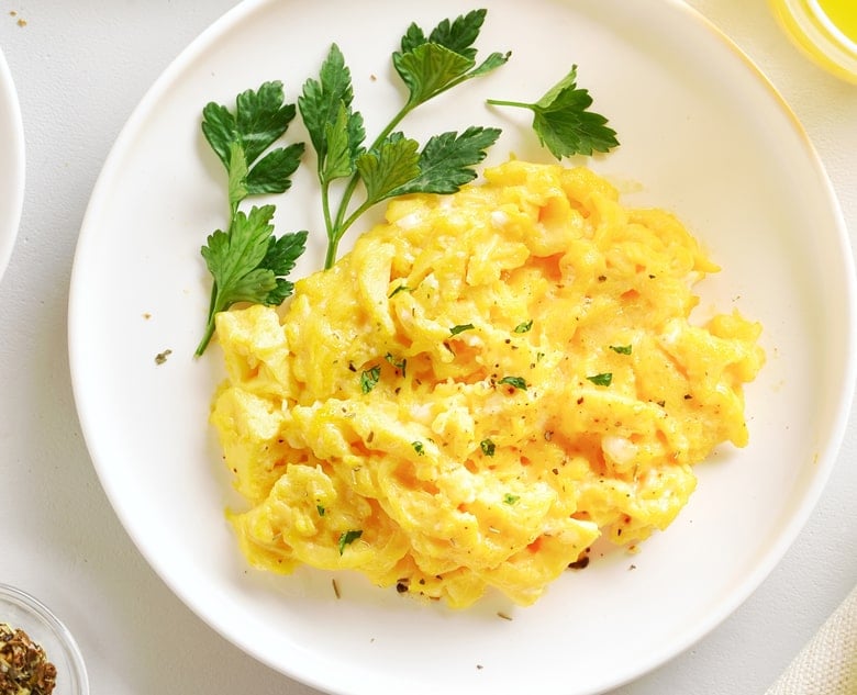 white plate with scrambled eggs