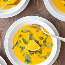 overhead shot of lentil soup with orange slice