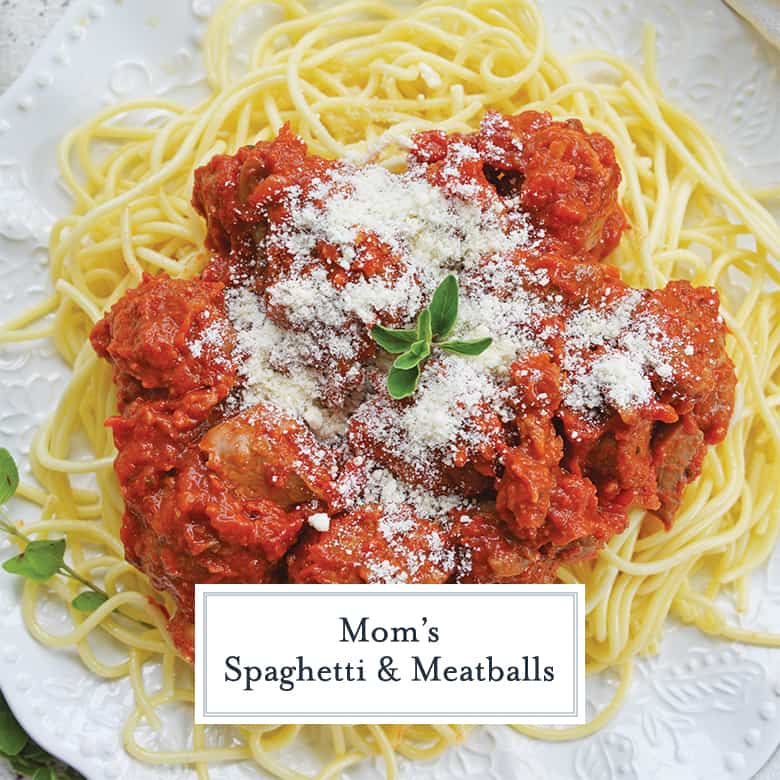 plate of spaghetti with meatballs topped with parmesan cheese