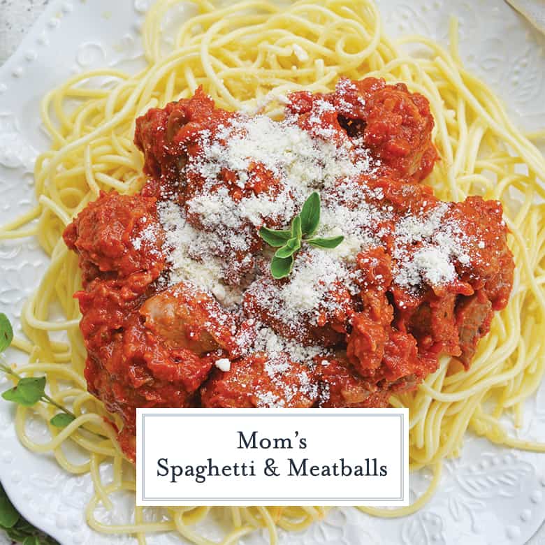 plate of spaghetti with meatballs topped with parmesan cheese 