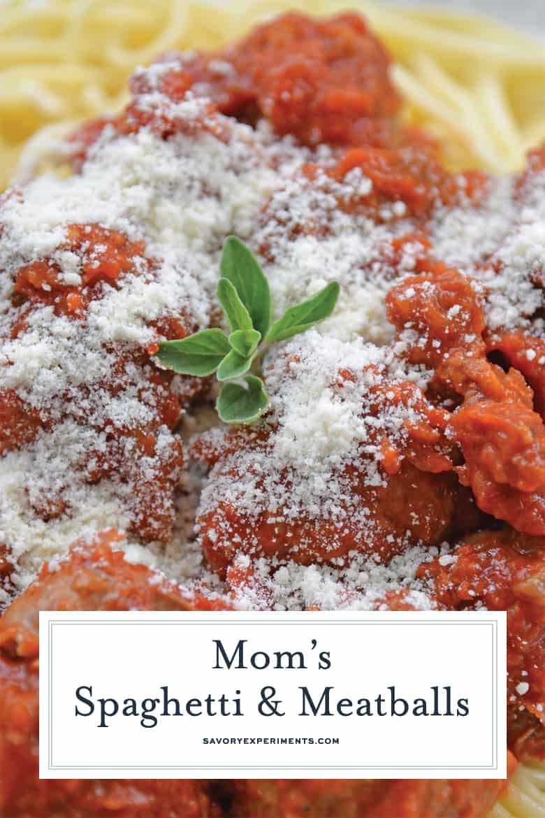 close up of spaghetti and meatballs with fresh oregano 