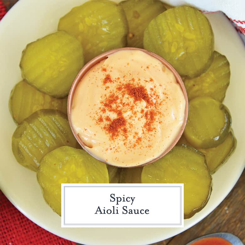 Spicy aioli sauce sprinkled with smoked paprika and surrounded by pickles 
