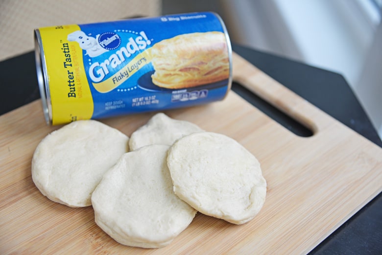 Buttery and delicious Air Fryer Donuts in just 10 minutes and using only 4 ingredients. Coated in cinnamon sugar, these are going to be your new favorite! #airfryerdonuts #homemadedonuts www.savoryexperiments.com 