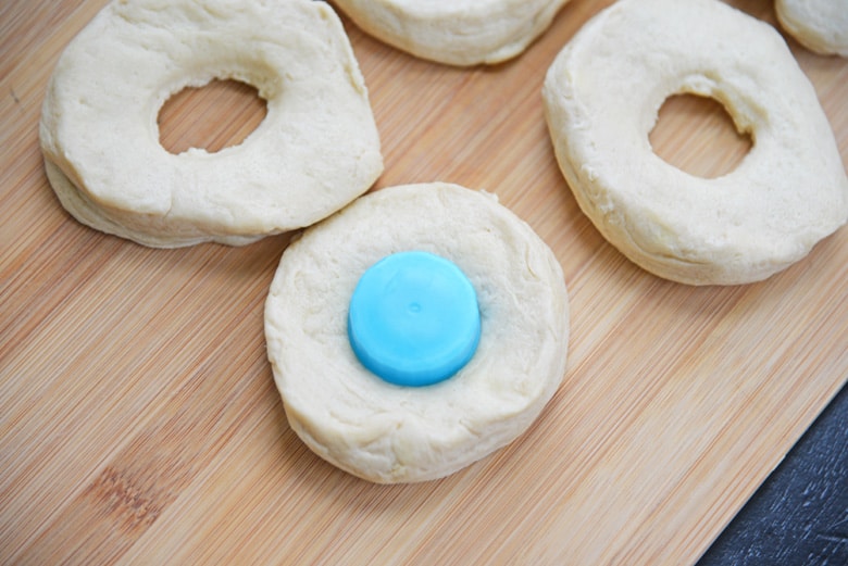 bottle top used as a cookie cutter for doughnuts 
