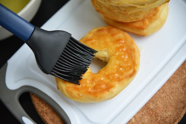 basting butter onto a doughnut 