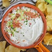 bowl of bacon ranch dip with scallions and potato chips