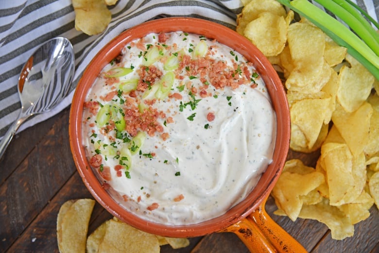bowl of bacon ranch dip with scallions and potato chips 