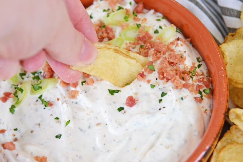 chip dipping into potato chip dip 