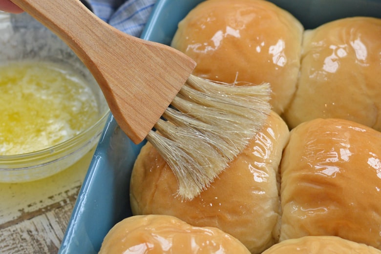 butter basting on homemade dinner rolls 