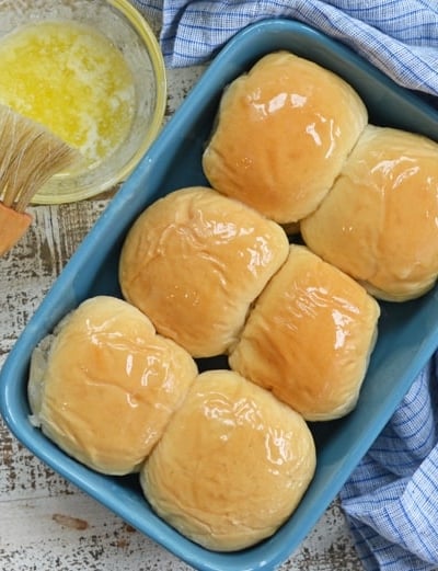 buttered dinner rolls in a blue baking dish